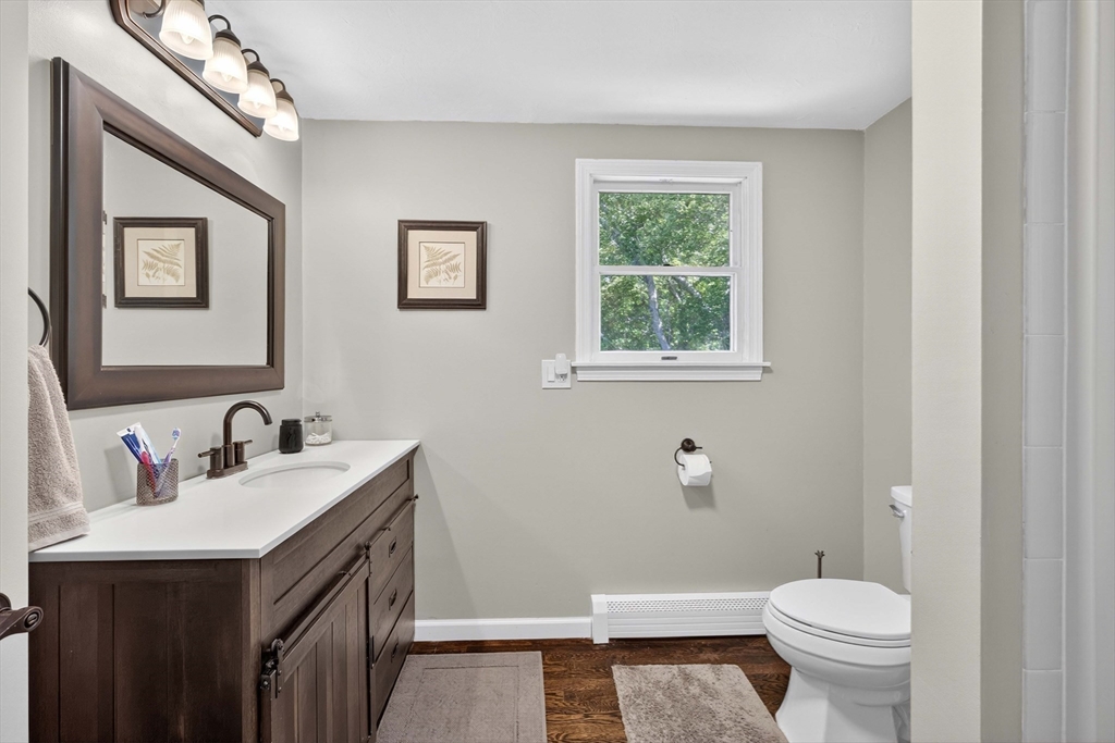181 Head Of The Bay Road Bourne, MA 02532 - Photo 17 of 34 a bathroom with a sink toilet and a mirror