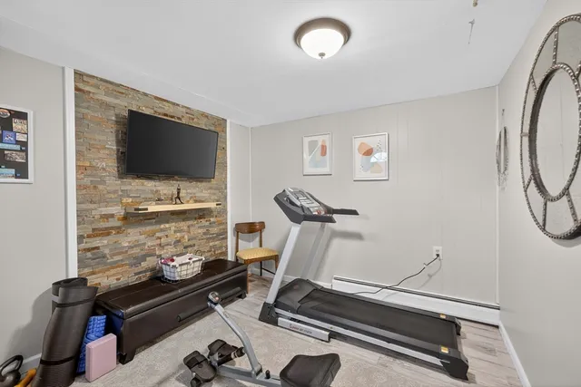 a room with gym equipment and a flat screen tv