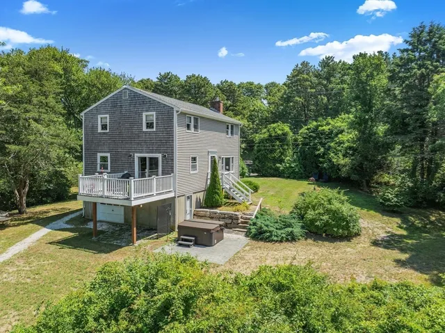 a view of a house with backyard and sitting area