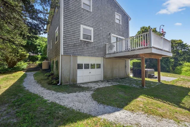 a view of a house with a yard and sitting area