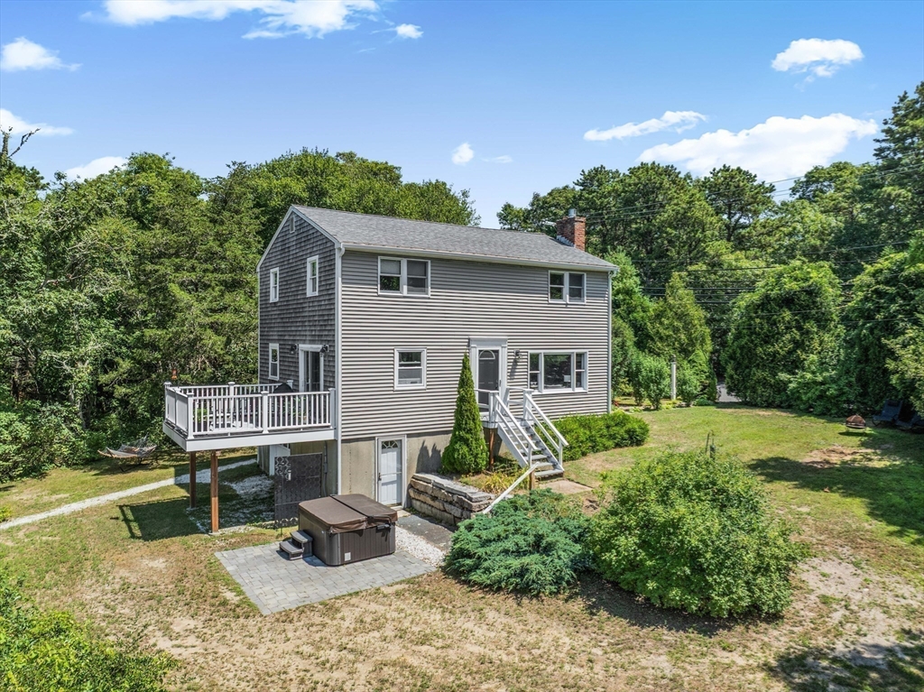 181 Head Of The Bay Road Bourne, MA 02532 - Photo 3 of 34 a view of a house with backyard sitting area and garden
