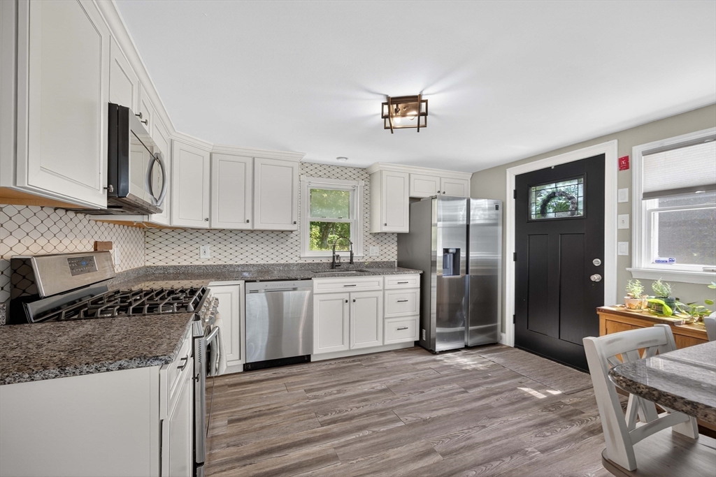 181 Head Of The Bay Road Bourne, MA 02532 - Photo 4 of 34 a kitchen with granite countertop a refrigerator stove top oven and sink
