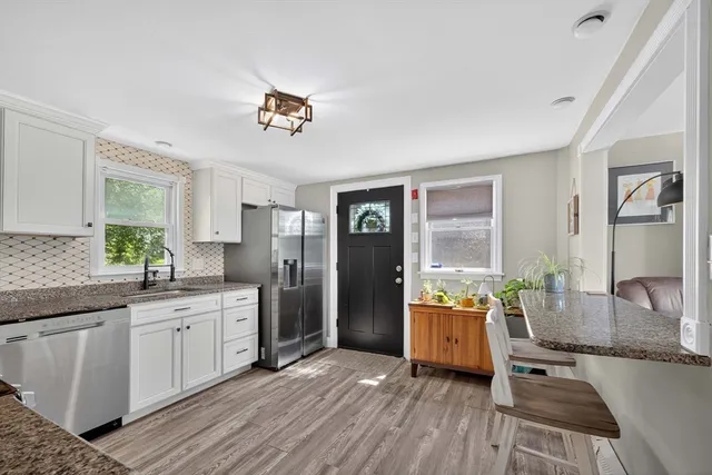 a kitchen with a sink a counter top space and stainless steel appliances