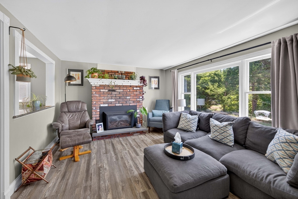 181 Head Of The Bay Road Bourne, MA 02532 - Photo 7 of 34 a living room with furniture fireplace and a large window