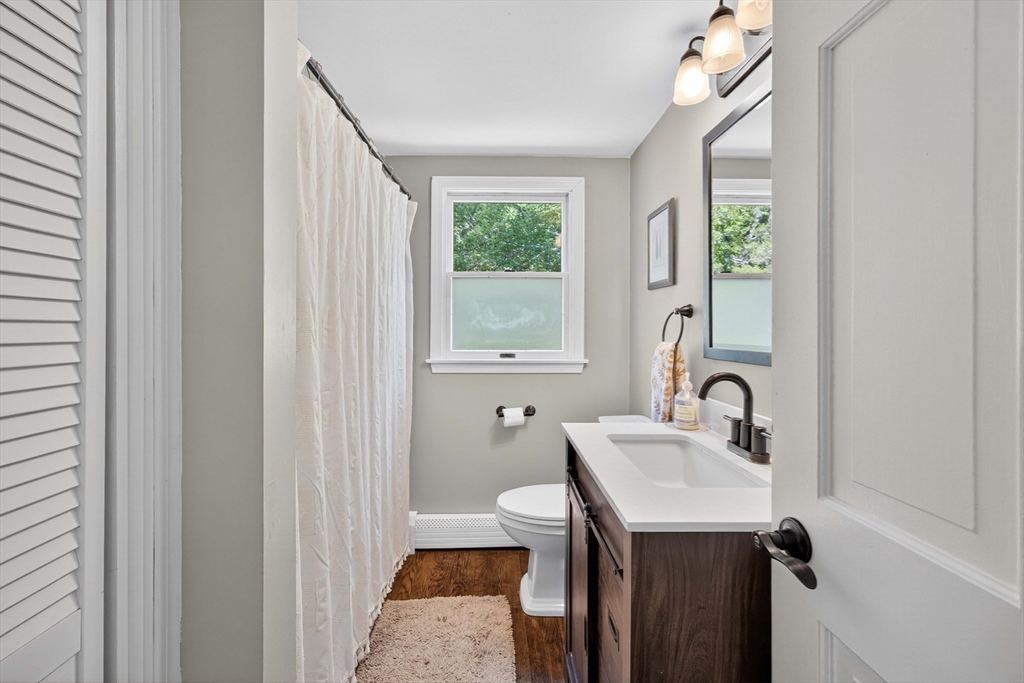 181 Head Of The Bay Road Bourne, MA 02532 - Photo 9 of 34 a bathroom with a sink a toilet and a mirror