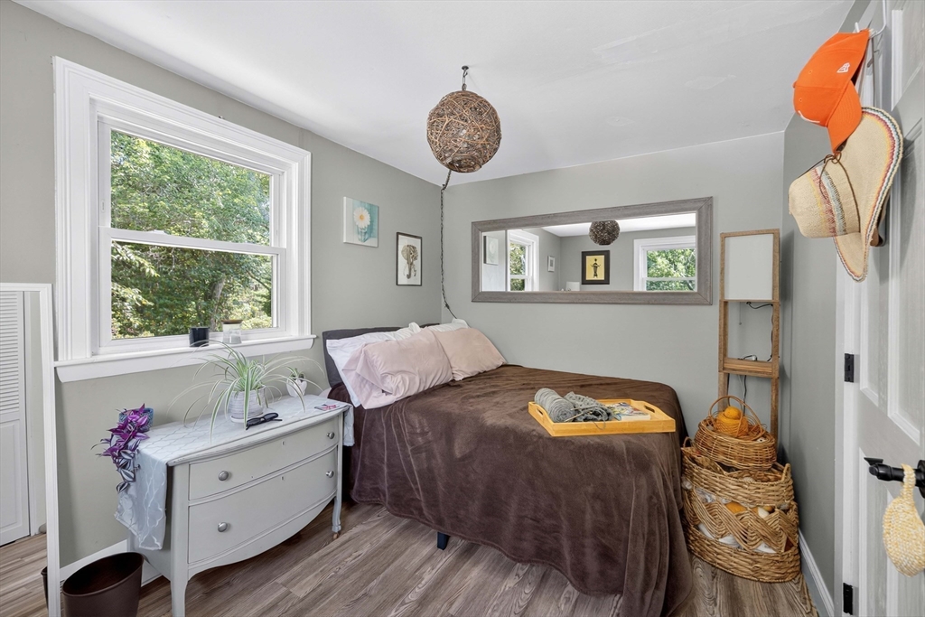 181 Head Of The Bay Road Bourne, MA 02532 - Photo 10 of 34 a bedroom with a bed and a chandelier