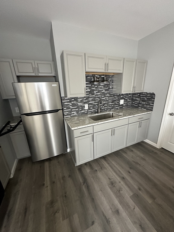 371 Dickinson Street, Unit 2 Springfield, MA 01108 - Photo 1 of 9 a kitchen with stainless steel appliances a refrigerator a sink a stove and white cabinets