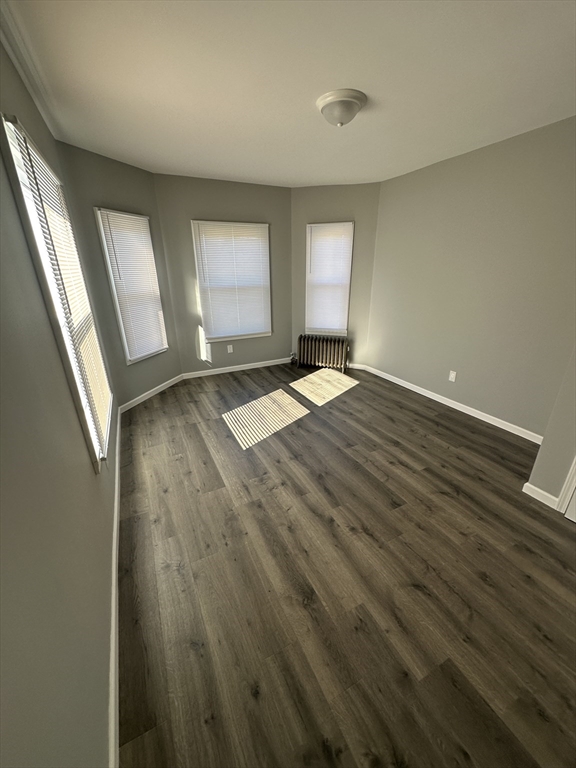 371 Dickinson Street, Unit 2 Springfield, MA 01108 - Photo 3 of 9 an empty room with wooden floor and windows