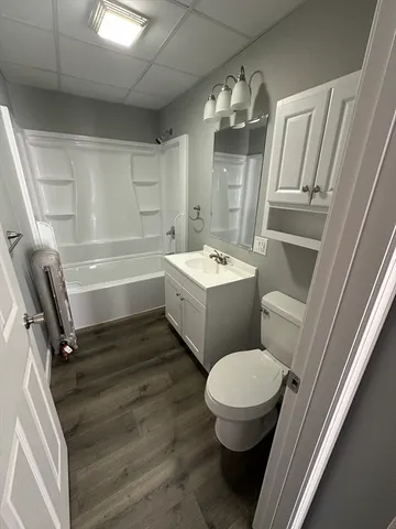 a bathroom with a sink a toilet and tub