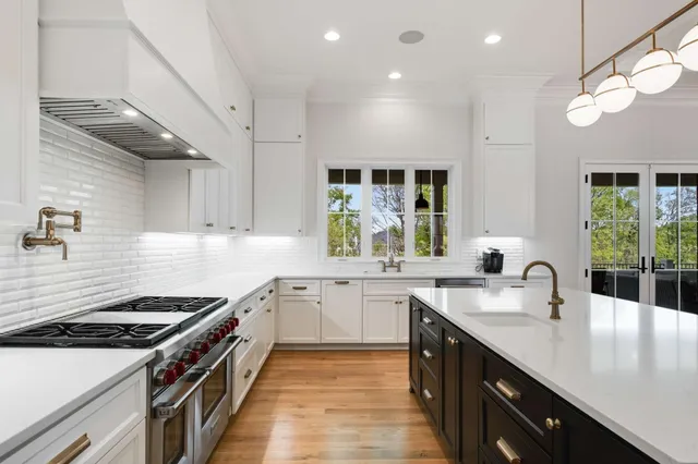 a kitchen with cabinets appliances and a wooden floor