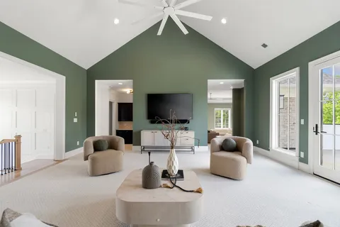 a living room with furniture gym equipment and a large window