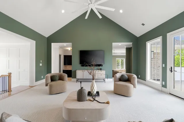 a living room with furniture gym equipment and a large window