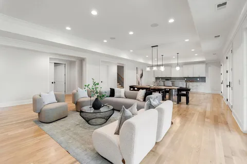 a living room with fireplace furniture and a large window