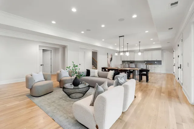 a living room with fireplace furniture and a large window