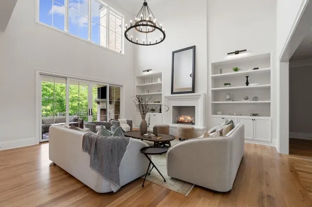 a view of a dining room with furniture a chandelier and wooden floor
