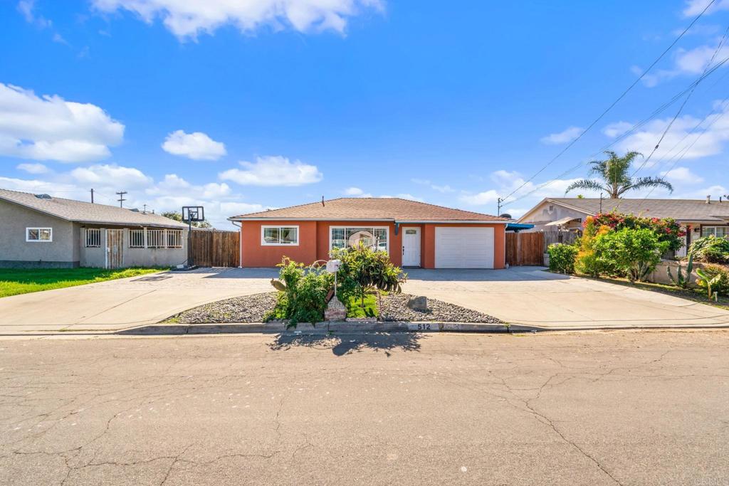 512 Tatum Street Vista, CA 92083 - Photo 2 of 26 a front view of a house with a yard and garage