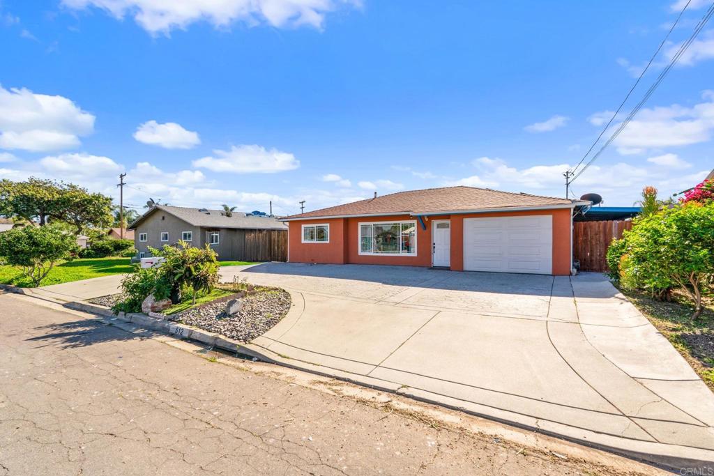 512 Tatum Street Vista, CA 92083 - Photo 4 of 26 a front view of a house with a yard and garage