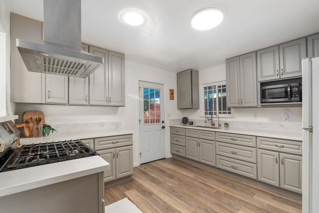 512 Tatum Street Vista, CA 92083 - Photo 8 of 26 a kitchen with sink stove and cabinets