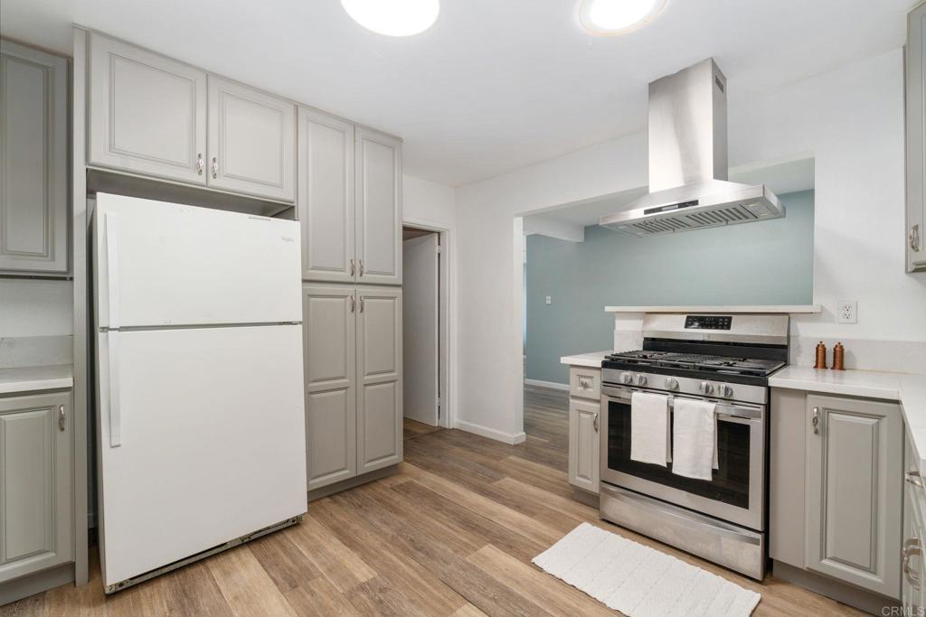 512 Tatum Street Vista, CA 92083 - Photo 9 of 26 a kitchen with a stove top oven and refrigerator