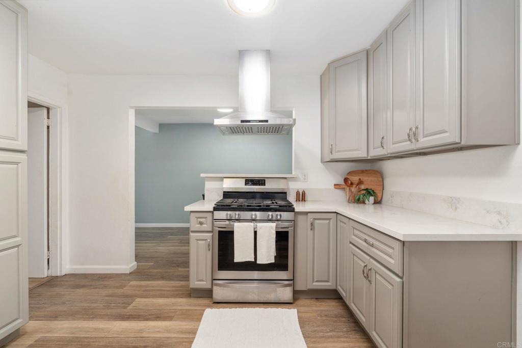 512 Tatum Street Vista, CA 92083 - Photo 10 of 26 a kitchen with a stove top oven and cabinets