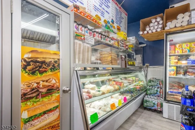 a utility room with stainless steel appliances lots of wooden furniture