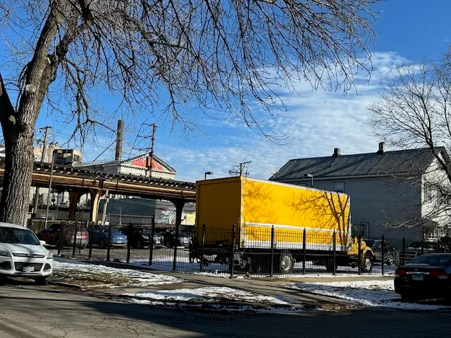 a view of building with car parked
