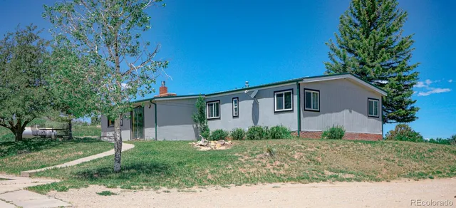a house that has a tree in front of it