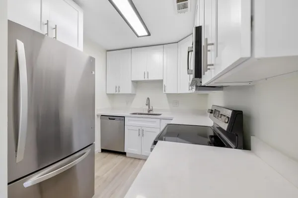 a kitchen with a refrigerator sink and stove