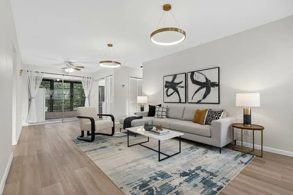 a living room with furniture and a wooden floor