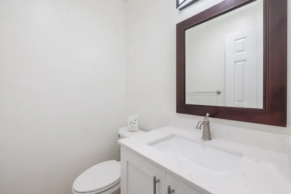 a bathroom with a sink a toilet and mirror