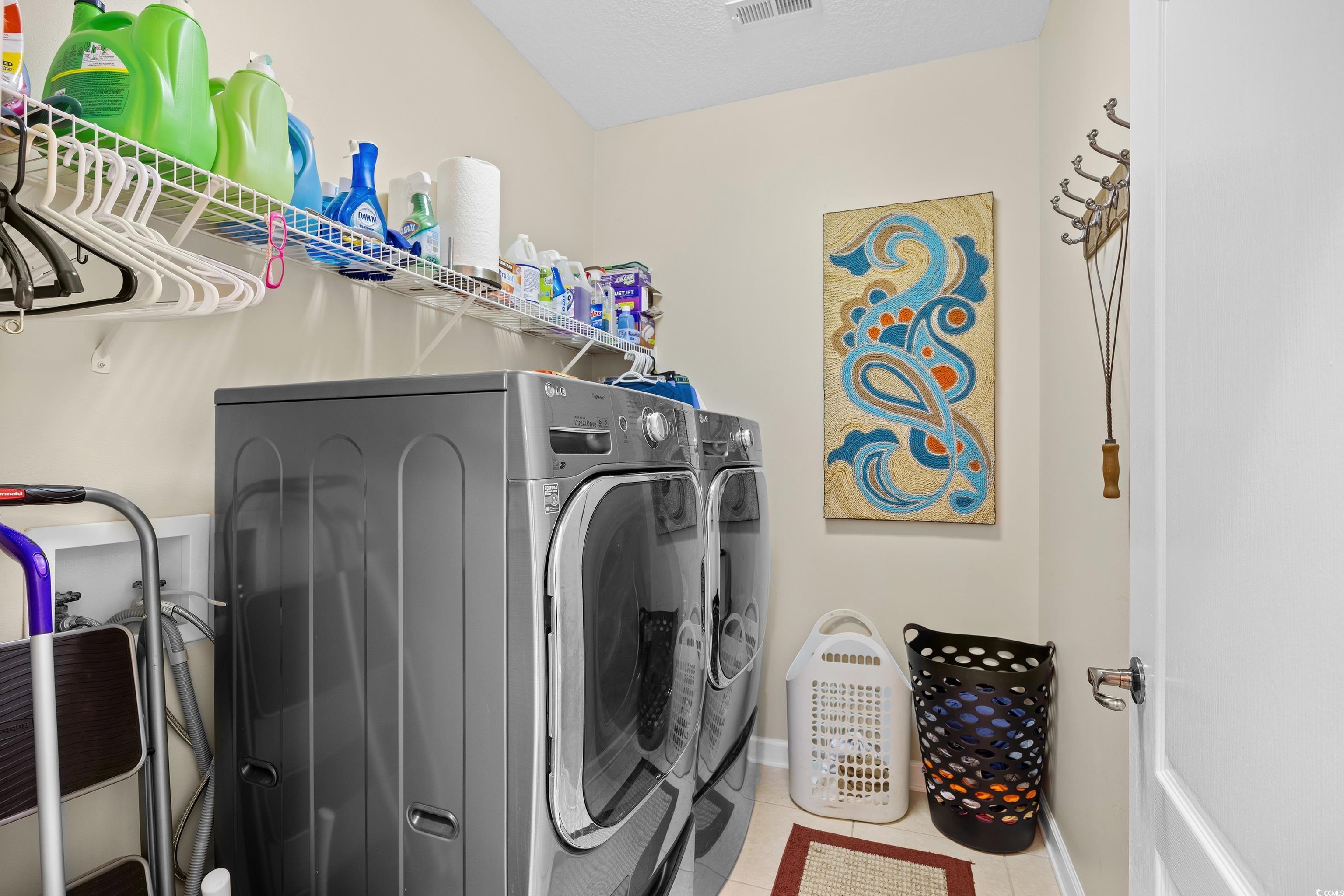 107 Fox Den Drive Murrells Inlet, SC 29576 - Photo 30 of 40 Laundry area with washing machine and clothes dryer and tile patterned floors