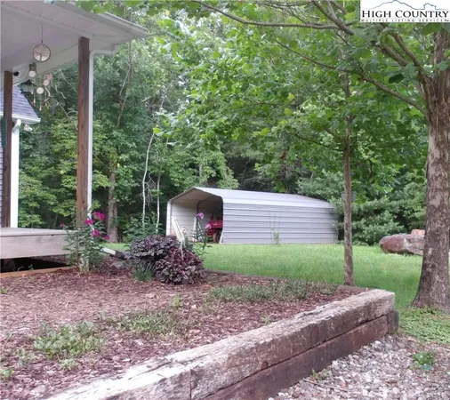 a backyard of a house with plants and outdoor seating