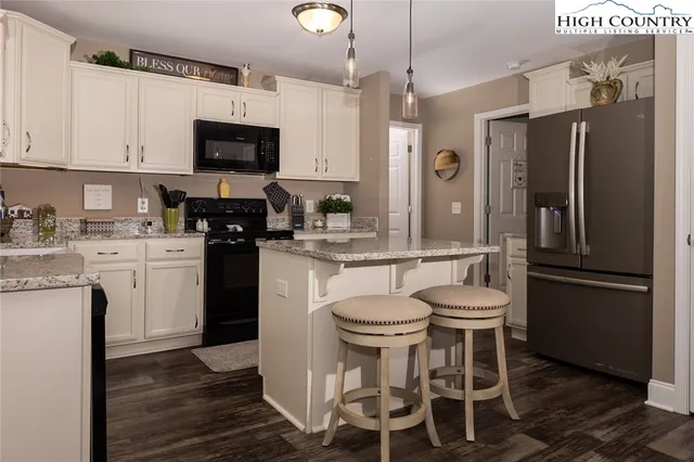 a kitchen with a sink appliances and cabinets