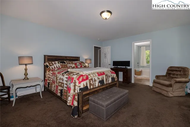 a bedroom with a bed and chair