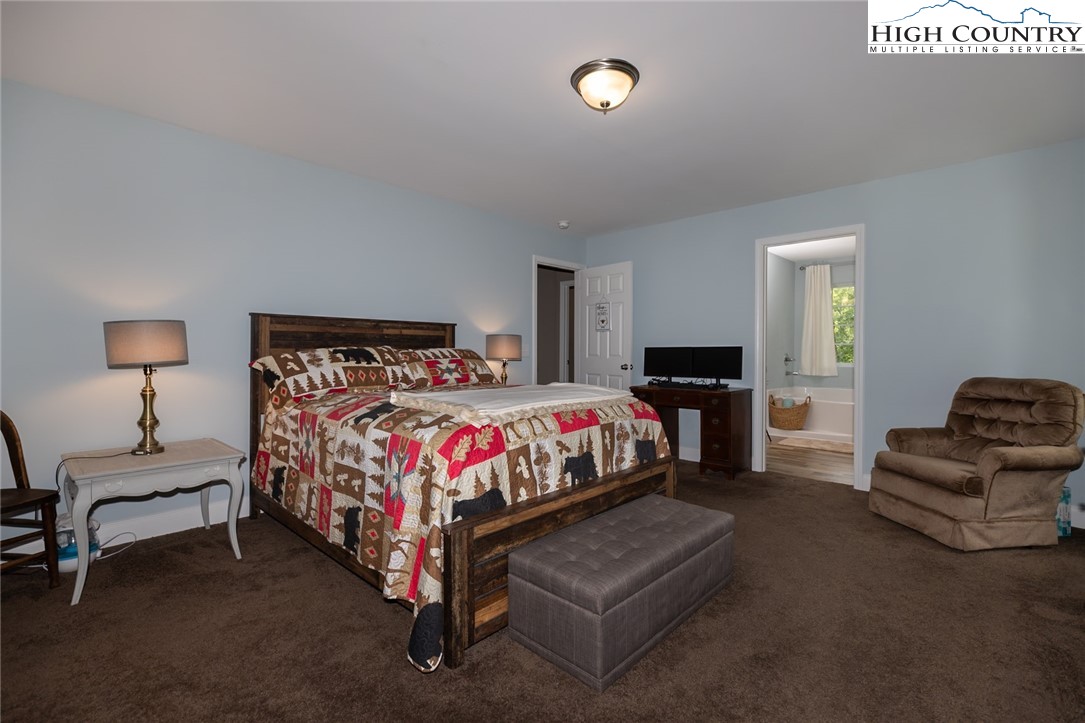 351 Colony Lane Purlear, NC 28665 - Photo 28 of 39 a bedroom with a bed and chair