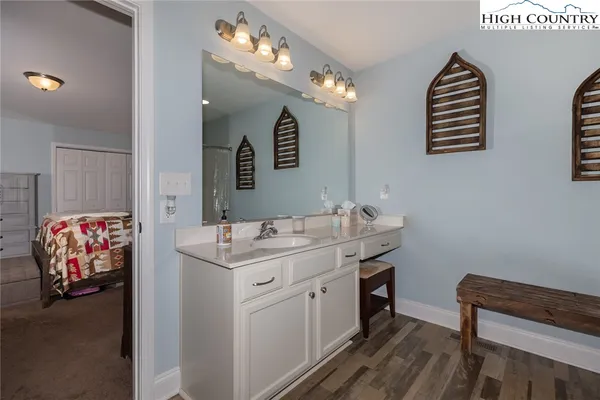a bathroom with a sink a vanity and a mirror