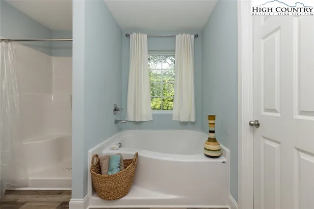 a bathroom with a bathtub and window