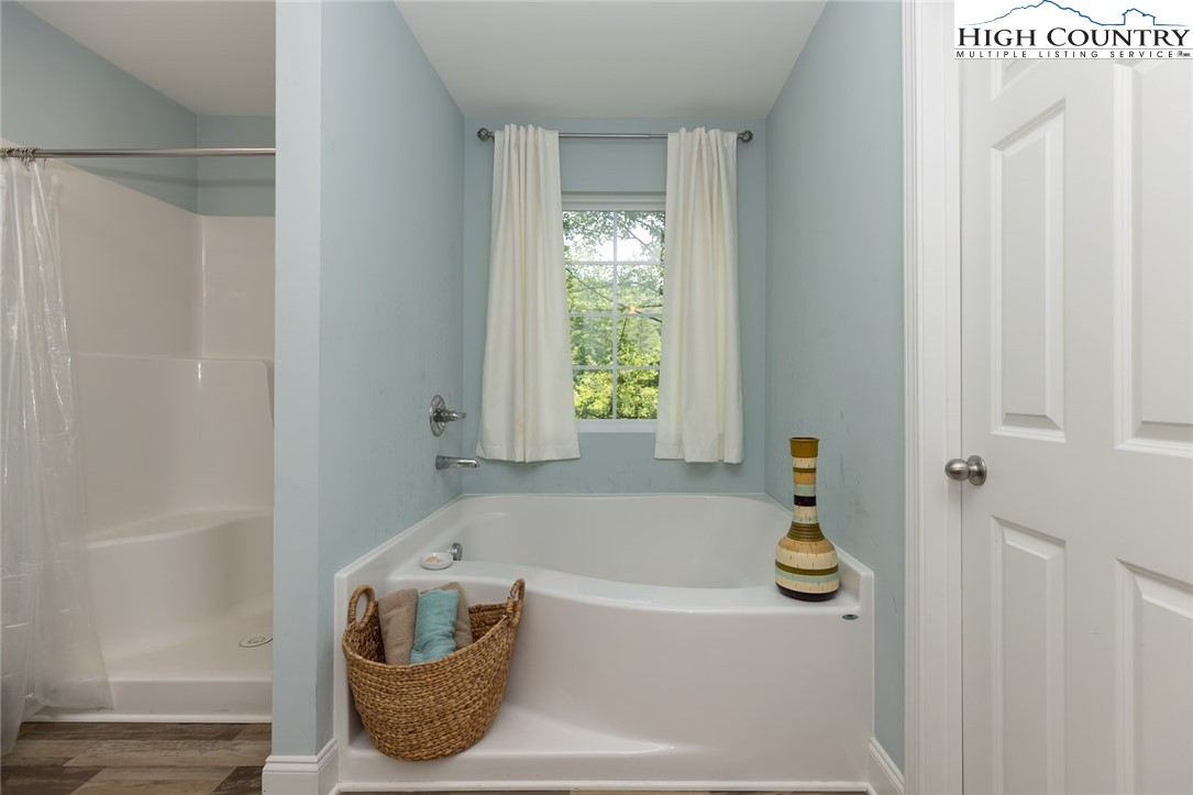 351 Colony Lane Purlear, NC 28665 - Photo 32 of 39 a bathroom with a bathtub and window