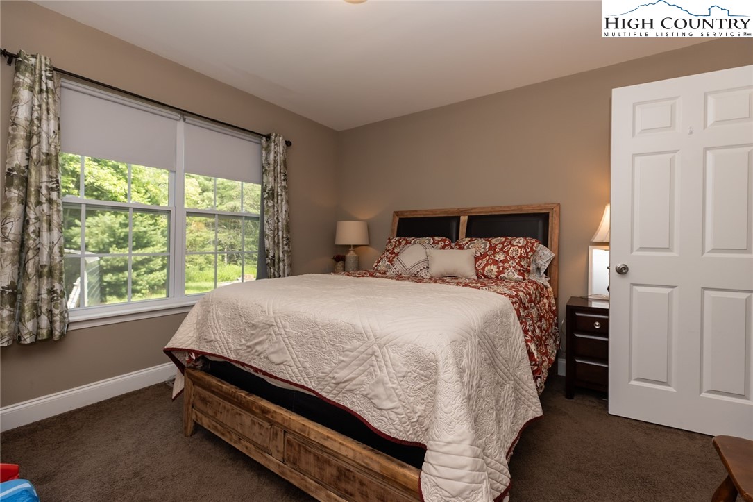 351 Colony Lane Purlear, NC 28665 - Photo 34 of 39 a bed sitting in a bedroom next to a window