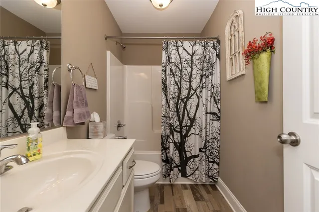 a bathroom with a sink toilet and shower