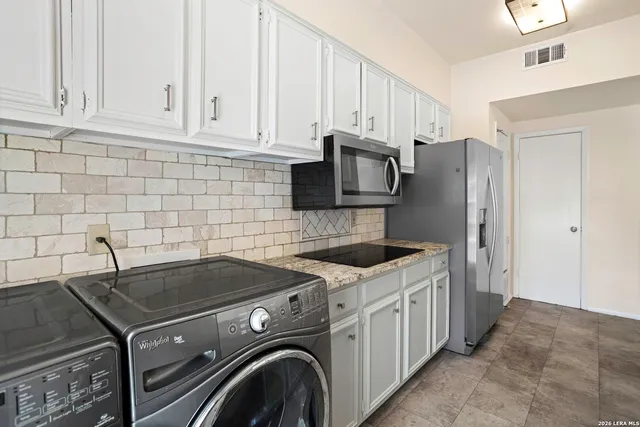 a kitchen with a stove and a refrigerator