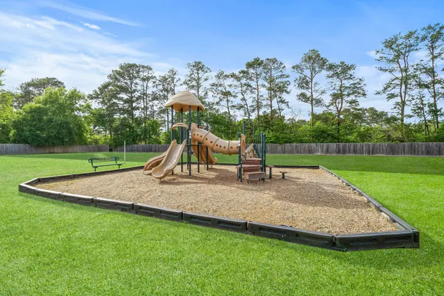a view of outdoor space with playground and green space
