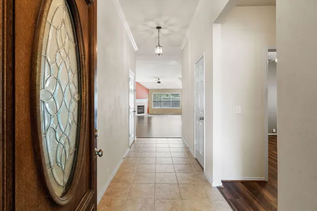 a view of a hallway with wooden floor and entryway