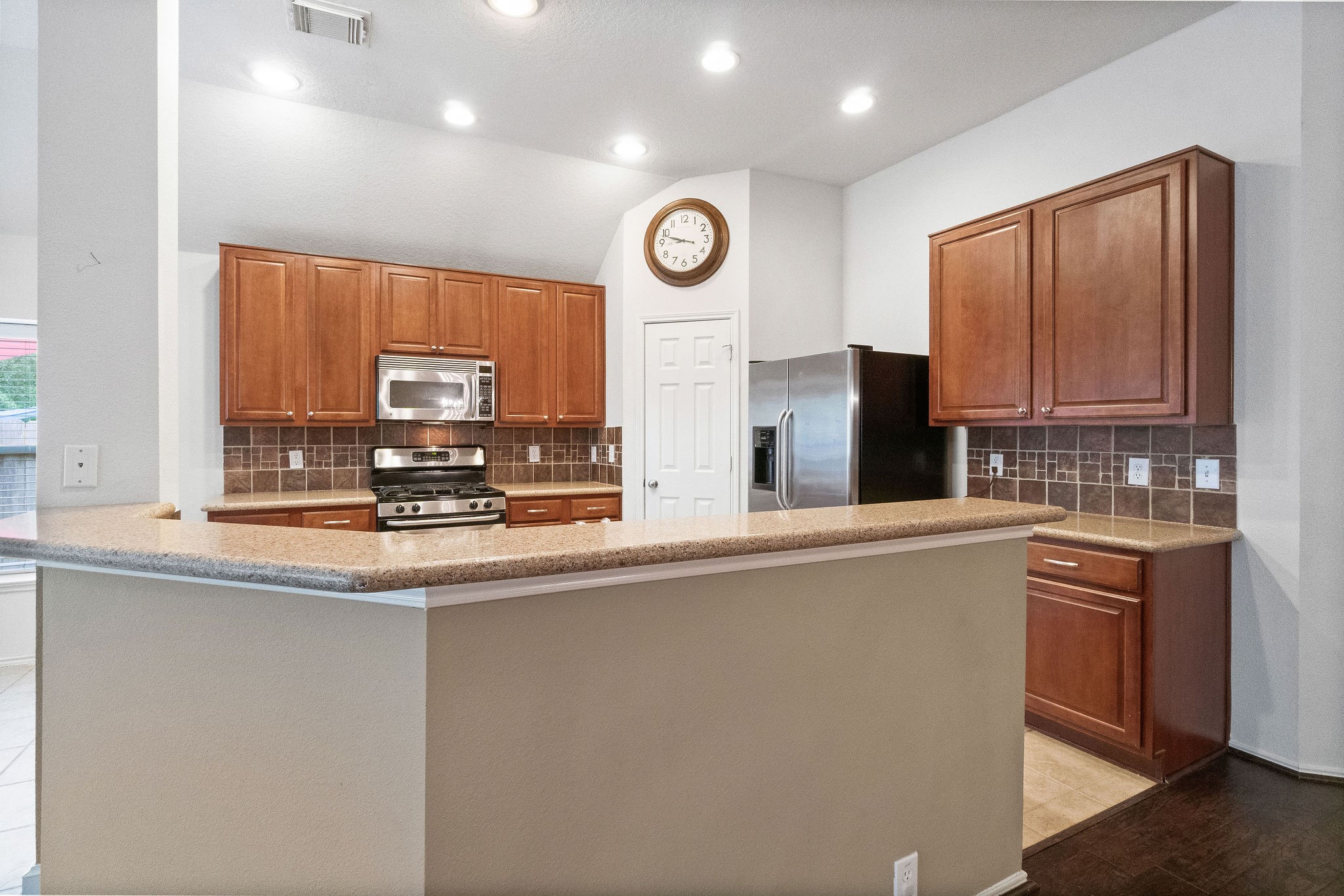 17423 Renee Springs Court Spring, TX 77379 - Photo 19 of 19 a kitchen with stainless steel appliances granite countertop a stove a sink and a microwave