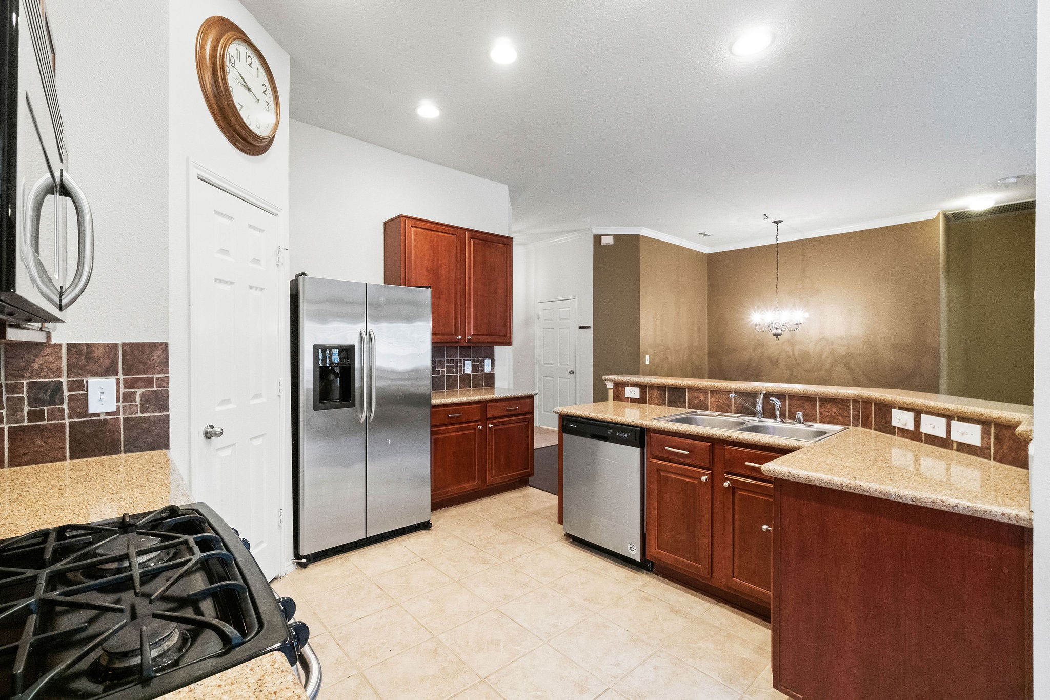 17423 Renee Springs Court Spring, TX 77379 - Photo 6 of 19 a kitchen with stainless steel appliances granite countertop a sink and a stove