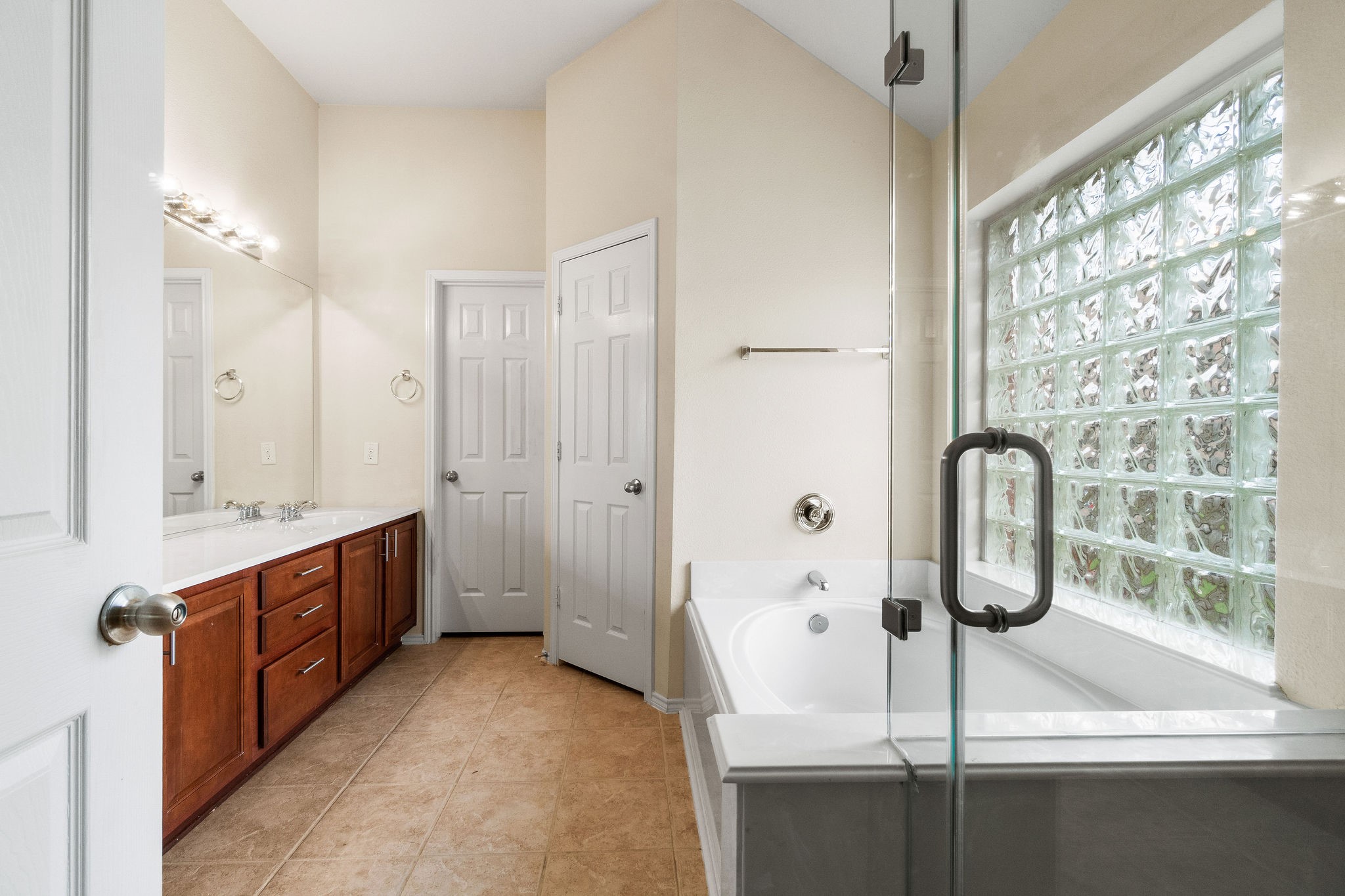 17423 Renee Springs Court Spring, TX 77379 - Photo 9 of 19 a en suite bathroom with a granite countertop sink mirror and bathtub
