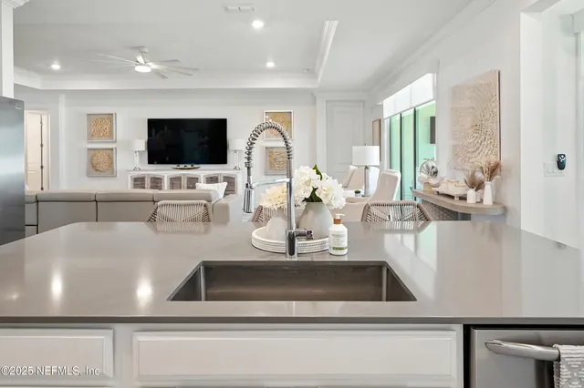 a kitchen with stainless steel appliances granite countertop white cabinets and black stove top oven with granite countertops