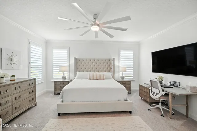 a bedroom with a large bed and a chandelier