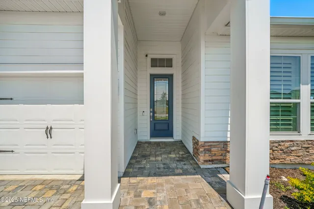 a view of a hallway view with wooden floor and a bathroom