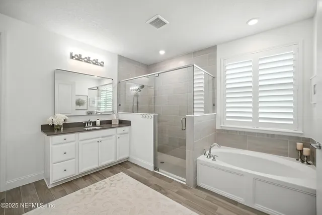 a bathroom with a double vanity sink and mirror